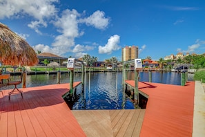Guests can relax on the dock with a chair and table overlooking the water.