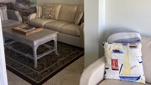 A living room with a sofa, coffee table, and patterned rug. - Best deal on the beach/sleeps 6/All New/Gulf views!/55 inch TV (Indian Shores)