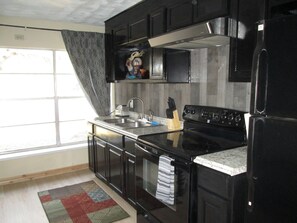 Fridge, microwave, oven, stovetop - Always Home In Texas Cabin with  WiFi, and plenty of yard.  (Brownwood)