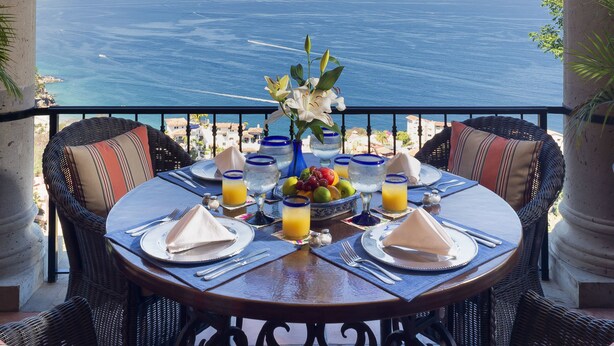 A dining table set for two with a view of the sea. - Spacious Open-Air Villa w/Unequaled Luxury/Views, 5 Mins to Town, Chef & Staff (Puerto Vallarta)