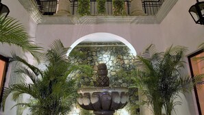 A multi-level atrium with a central fountain, columns, and potted plants. - Spacious Open-Air Villa w/Unequaled Luxury/Views, 5 Mins to Town, Chef & Staff (Puerto Vallarta)