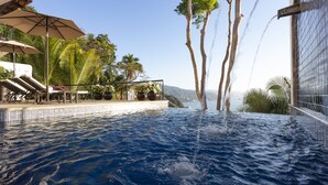 A pool with water jets, surrounded by palm trees and a view of the ocean. - Spacious Open-Air Villa w/Unequaled Luxury/Views, 5 Mins to Town, Chef & Staff (Puerto Vallarta)
