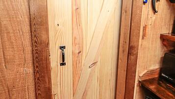 A wooden door with a black handle and a metal latch.