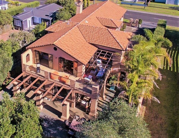 A large house with a spacious deck and a swimming pool.