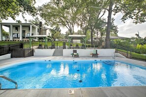 A swimming pool with a 5 FT depth marker, surrounded by a covered patio area with chairs and a gazebo. - 2 Mi to Branson Strip: Cozy Cottage w/ Fire Pit! (Branson)