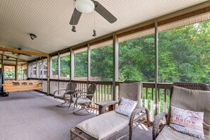 A covered outdoor seating area with wicker furniture and a ceiling fan. - Hot Tub & Mtn Views: Beautiful Bryson City Home (Bryson City)