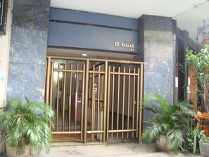 A hotel entrance with a metal gate, potted plants, and a sign reading "ED. DALLAS 420". - MARCELO'S APARTMENT - COPACABANA (Rio de Janeiro)