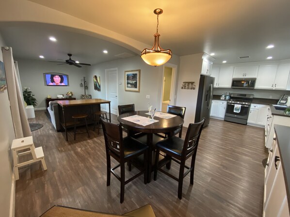A modern kitchen with white cabinets, a stainless steel refrigerator, and a built-in oven. - Relaxing, Romantic, and Fun!  Private, Quiet, and Less than a mile to the Ocean! (Oceanside)