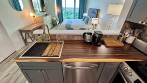 A modern kitchen with a built-in stove, coffee maker, and a view of the city. - Balcony Ocean Views | Pool, Gym, Wi-Fi & Parking (Miami)