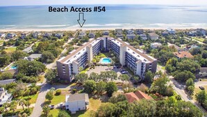 A resort with a central pool, multiple buildings, and a beach access point. - Retreat 514 - 2nd Row, Great View, Pool, Ocean! (Pawleys Island)