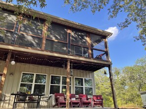 A two-story building with large windows and a covered porch area. -  A Beautiful Escape from the City. Explore Nature and Enjoy the Lake! (Hillsboro)