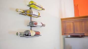 A wall-mounted wine rack with several bottles.