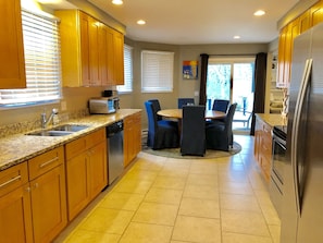 Enjoy meals and socializing around the central island with seating in this well-equipped kitchen.