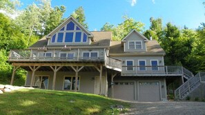 A two-story house with a balcony, a garage, and a staircase leading to the upper level.