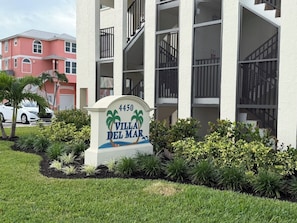 A sign for Villa Del Mar at 4450, surrounded by well-maintained landscaping. - Mid Island, Villa Del Mar!  Beautiful Beach front condo, newly renovated! (Fort Myers Beach)
