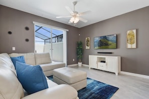 Relax in this inviting living space with a comfortable sofa, flat-screen TV, and stunning mountain views.