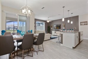 Enjoy meals with family and friends in this spacious dining area, complete with a table for four and comfortable seating.