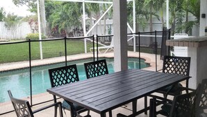 A covered patio with a pool table, chairs, and a ceiling fan. - 4 BR/3 BA Villa, Private Pool - Near Chabad & Anshei (Boynton Beach)