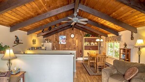 A cozy interior with a kitchen, dining area, and living room. - Abbott Brook Chalet A - Private Setting - 5 Mi  From Storyland (Intervale)