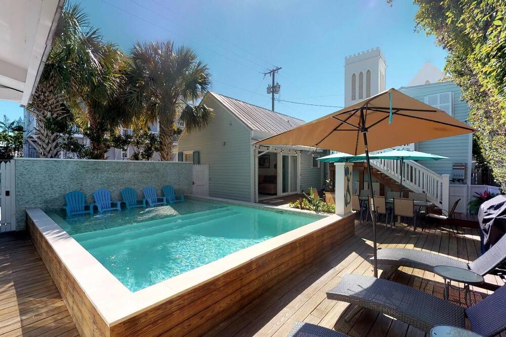WELCOME TO ISLAND TIME! <br>Key West Island Time is a rare find in old town Key West. It is a total of 5 bedrooms and three bathrooms in 2 separate cottages with full amenities that has just been renovated and tastefully updated.The property can accommodate a maximum of 12 people.<br><br>Both cottages are furnished beautifully, while retaining a charming vintage feel that this historical property affords us. Built in 1888 both cottages encompass one private, gated property with an oversized pool and waterfall, dining area, lounging, and grilling for your pleasure. The main house has two bedrooms and one full bathroom, living room, kitchen and dining area. There is one king bed in the oversized master bedroom and two twins in the guest room that can be converted to a king upon request.<br><br>The second cottage has two bedrooms, both with queen beds, and one full bathroom, living room, dining room and kitchen plus a front porch with rocking chairs, which is a favorite spot for guests to enjoy morning coffee, or evening cocktails. From the porch, you can watch the Conch Train come by a few times a day and discuss our historical home on their tour.<br><br>There is also a separate loft as well, with one king bed, two twin beds, a full bathroom, seating area and kitchenette.<br>There is an outdoor shower plus 2 separate laundry areas.<br>The proximity to Old Town is a real plus, being close to everything within walking distance: restaurants, shopping, Churches, beaches, multiple museums and live music.<br>For the more adventurous vacationers, there is a bicycle rental shop one block away.<br>Welcome to Island Time!<br><br>Bedding Configurations:<br>801 Fleming-1 Queen in 1 Bdrm, 2 twins in second bdrm<br>807-1 Queen in each bdrm<br>Loft-1 King and 2 twins<br><br>3D Walkthroughs available on the RealKeyWest website.<br>801 Home: <br>807 Home: <br>The Loft: <br><br><br>Monthly Rental Only (This property must be rented for 28 or more days by city ordinance)<br>Small dogs 20 pounds or less will be accepted with a $200 non refundable fee. Maximum 2. ISLAND TIME - 5 Bed/3 Bath OldTown Complex - MONTHLY - Private pool