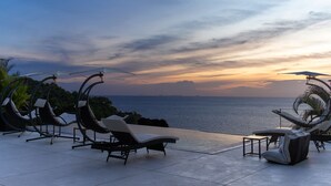 A sunset view from a rooftop terrace with lounge chairs and a pool. - The  new luxury architect modern villa in  Haad Yao  with huge amazing seaview. (Ko Pha Ngan)