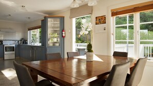 A kitchen with a dining area, a built-in cabinet, and a window with a view of the outdoors. - Escape North - Extended Family Retreat, located in central Russell (Russell)