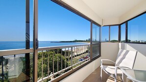 A balcony with a view of the sea and a chair. - Parkyn Place 6 - Three Bedroom Oceanview Apartment on Mooloolaba Spit (Mooloolaba)