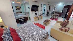 A modern living room with a sofa, a coffee table, and a TV.