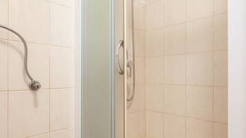 Shower, hair dryer, slippers, towels