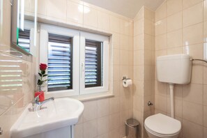 Shower, hair dryer, slippers, towels