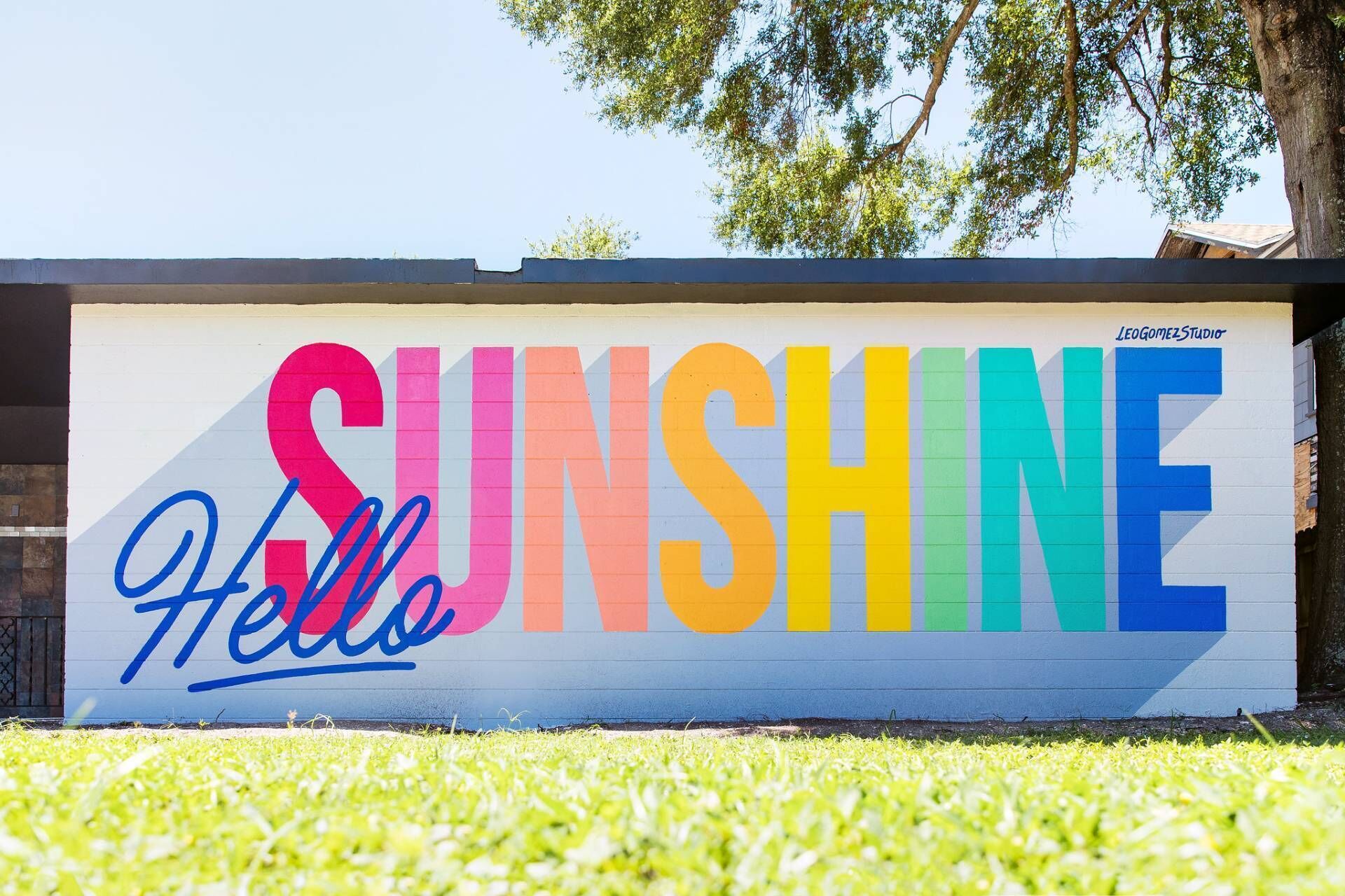 A wall with the word 'SUNSHINE' and 'Hello' painted in colorful letters.