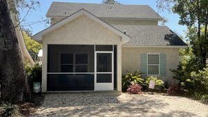 A two-story house with a garage, a covered entryway, and a landscaped front yard.