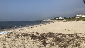 A beach with houses in the background.