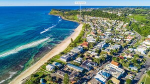 An aerial view of a coastal residential area with a beach, houses, and a labeled section called "The Quarterdeck." - Quarterdeck 4 @ Lennox Head (LENNOX HEAD)