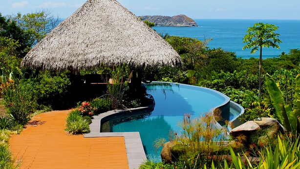 A thatched-roof structure with a pool and a wooden deck. - Villa Bella Vista:  Views, Privacy & Beach Proximity, We Have It All Right Here (manuel antonio)
