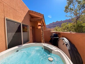 A hot tub in a covered outdoor area with a mountain view. - Cairn House - 4A7 (Moab)