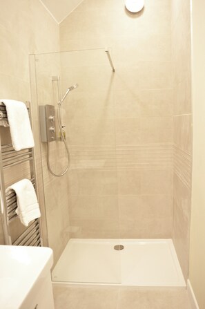 Bathtub, eco-friendly toiletries, hair dryer, towels