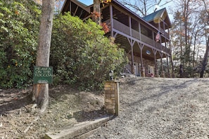 A cabin with a sign reading 'Heaven on the Toccoa,' indicating a cabin rental.