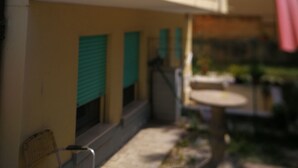A building with a balcony and a door with shutters. - VENICE LIDO, SEA AND CINEMA<br>...  (Venezia)