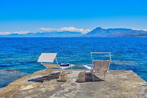 On the beach, sun loungers, beach towels
