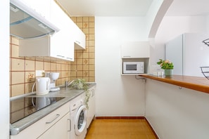 Fridge, microwave, coffee/tea maker, cookware/dishes/utensils