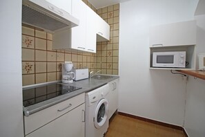 Fridge, microwave, coffee/tea maker, cookware/dishes/utensils