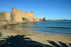 A coastal fortification with a beach in the foreground.
