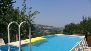 An outdoor swimming pool with a view of the countryside. - FANTASTIC RURAL HOUSE IN FULL RELAXATION IN THE HILLS WITH SWIMMING POOL (CIVITELLA DI ROMAGNA)
