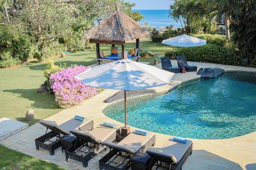 Fabulous villa right on the beach with large pool, tropical garden & staff