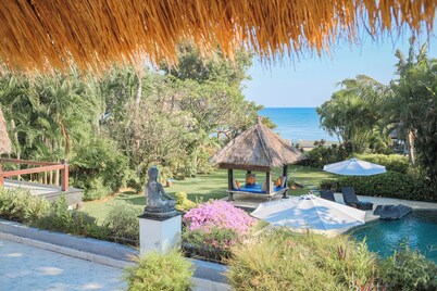 Fabulous villa right on the beach with large pool, tropical garden & staff