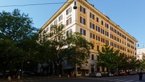 A multi-story building with a classic architectural style, featuring a symmetrical facade, multiple windows, and a prominent entrance. - Rome Boutique Apartments, seductive, close on foot to the vatican and the center (6900334)