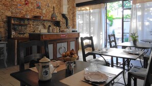 A rustic cafe with stone walls, wooden furniture, and a stone fireplace. - Bed & Breakfast in a Farmhouse- air conditionned - Lacoste (Lacoste)