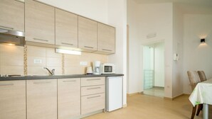 A modern kitchen with light wood cabinets, a built-in microwave, and a coffee maker. - Stunning private villa for 12 guests with hot tub, private pool, WIFI, A/C, TV and patio (Zadar)