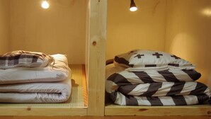 Two wooden bunk beds with light fixtures above them. - Kichinan - Hostel (Osaka)